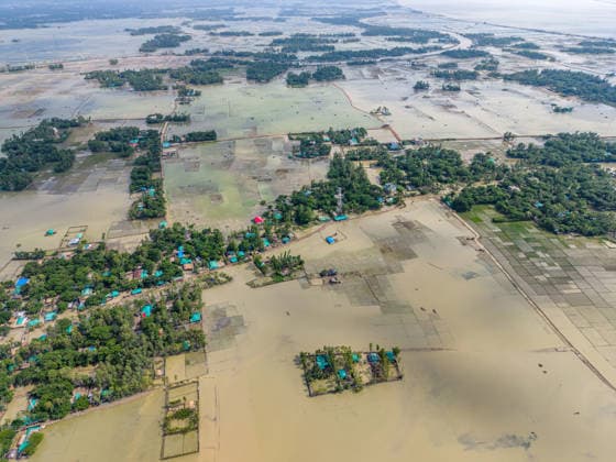 Aftermath Of Floodwaters In Chattogram A wide drone shot stretching to the horizon shows thousands of acres of agricultural land and villages submerged under monsoon floodwaters in Banshkhali, Chattogram, Bangladesh, on July 14, 2026. Although flood waters in Banshkhali and Satkania in Chittagong are slowly receding, many areas remain knee-deep in water. As the water recedes, collapsed mud houses, damaged structures, destroyed brick kilns and severely damaged agricultural land are becoming visible, displacing thousands of people. Chattogram Bangladesh  Copyright: xZakirxHossainx originalFilename: hossain-notitle260714_np5gj.jpg