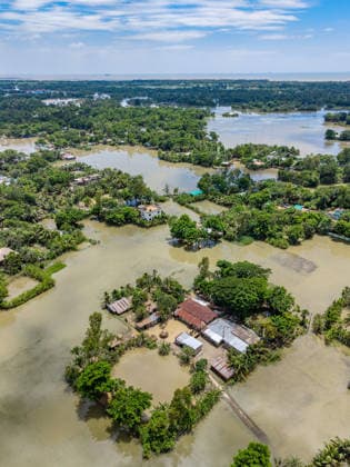 Aftermath Of Floodwaters In Chattogram An aerial view captured by a drone shows rural homesteads surrounded by stagnant floodwaters as water levels slowly begin to recede in Banshkhali, Chattogram, Bangladesh, on July 14, 2026. Flood waters in Banshkhali and Satkania in Chittagong are slowly receding, with many areas still knee-deep in water. As the water recedes, collapsed mud houses, damaged structures, destroyed brick kilns and severely damaged agricultural land are becoming visible, displacing thousands of people. Chattogram Bangladesh  Copyright: xZakirxHossainx originalFilename: hossain-notitle260714_np7bZ.jpg