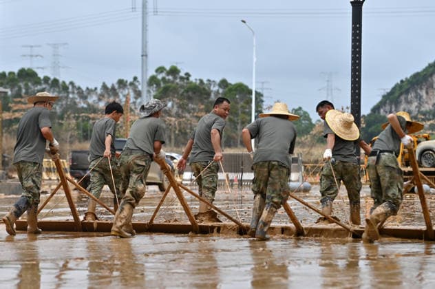 (260715) -- GUIGANG, July 15, 2026 -- People clear mud after flooding at a high school in Guigang, south China s Guangxi Zhuang Autonomous Region, July 15, 2026. Flood relief and recovery efforts were underway after the city was hit by severe rainstorms and flooding caused by Typhoon Maysak. ) CHINA-GUANGXI-GUIGANG-FLOOD-AFTERMATH (CN) LuxBoan 