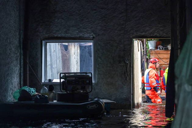 RUSSIA, SVERDLOVSK REGION - JULY 15, 2026: An emergency worker enters a house in the flood-hit village of Zaikovo, southwest of Irbit. Donat Sorokin TASS  95063754