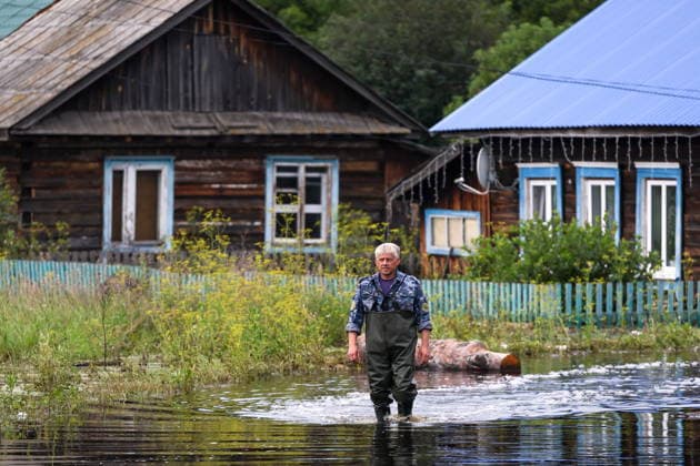 RUSSIA, SVERDLOVSK REGION - JULY 15, 2026: A man wades through floodwater in the village of Zaikovo, southwest of Irbit. Donat Sorokin TASS  95063756