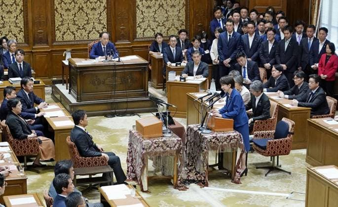 Japan PM Takaichi in parliament Japanese Prime Minister Sanae Takaichi (standing) speaks to Yuichiro Tamaki, leader of the opposition Democratic Party for the People, during one-on-one debates with opposition party leaders in parliament in Tokyo on July 15, 2026.  A14AA0005623204P