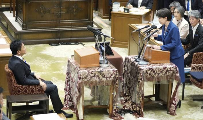 Japan PM Takaichi in parliament Japanese Prime Minister Sanae Takaichi (standing) speaks to Yuichiro Tamaki, leader of the opposition Democratic Party for the People, during one-on-one debates with opposition party leaders in parliament in Tokyo on July 15, 2026.  A14AA0005623205P