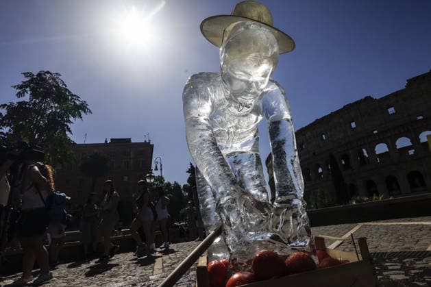 Greenpeace action on impact of global warming on workers in Italy ROME, ITALY, JULY 15: Ice statues representing a farm worker, a construction worker and a food delivery rider stand in front of the Colosseum after being placed by Greenpeace activists to melt under the sun during an awareness campaign highlighting the impact of global warming on workers, as a new heatwave grips in Rome, Italy on July 15, 2026. Seven cities were placed under a red alert on Wednesday, with the number expected to rise on Thursday, July 16, and temperatures forecast to exceed 40 degrees Celsius in many areas. Riccardo De Luca Anadolu Rome Italy. Editorial use only. Please get in touch for any other usage.  Copyright: x2026xAnadoluxRiccardoxDexLucax