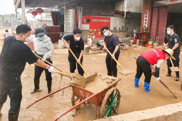 (260715) -- NANNING, July 15, 2026 -- Rescuers remove sludge in Yunbiao Town of Hengzhou City, Nanning City of south China s Guangxi Zhuang Autonomous Region, July 15, 2026. Efforts are underway to facilitate flood relief and recovery in Guangxi, which has been hit by severe rainstorms and flooding caused by Typhoon Maysak. (Photo by Xinhua) CHINA-GUANGXI-TYPHOON MAYSAK-AFTERMATH-RECOVERY (CN) LixYonghua 