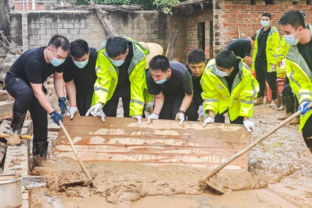 (260715) -- NANNING, July 15, 2026 -- Rescuers remove sludge in Yunbiao Town of Hengzhou City, Nanning City of south China s Guangxi Zhuang Autonomous Region, July 15, 2026. Efforts are underway to facilitate flood relief and recovery in Guangxi, which has been hit by severe rainstorms and flooding caused by Typhoon Maysak. (Photo by Xinhua) CHINA-GUANGXI-TYPHOON MAYSAK-AFTERMATH-RECOVERY (CN) LixYonghua 