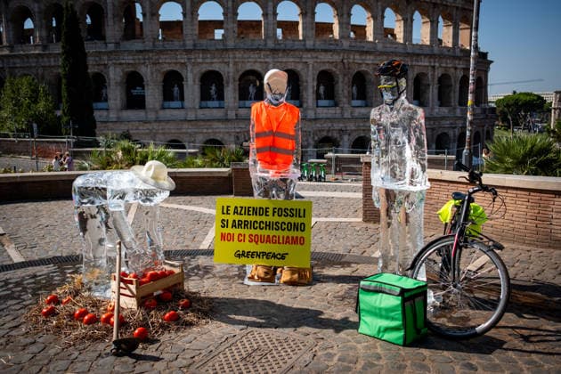 July 15, 2026, Rome, Rm, Italy: On the occasion of the European Day in remembrance of the victims of the global climate crisis, Greenpeace Italy activists let three ice statues melt in the sun near the Colosseum to denounce the impact of the climate crisis on workers. The statues depicted a farm worker, a construction worker, and a delivery driver, among the groups most exposed to heat waves. Fossil fuel corporations get rich, we melt reads the sign. Rome Italy - ZUMAg256 20260715_znp_g256_006 Copyright: xMarcoxDixGianvitox