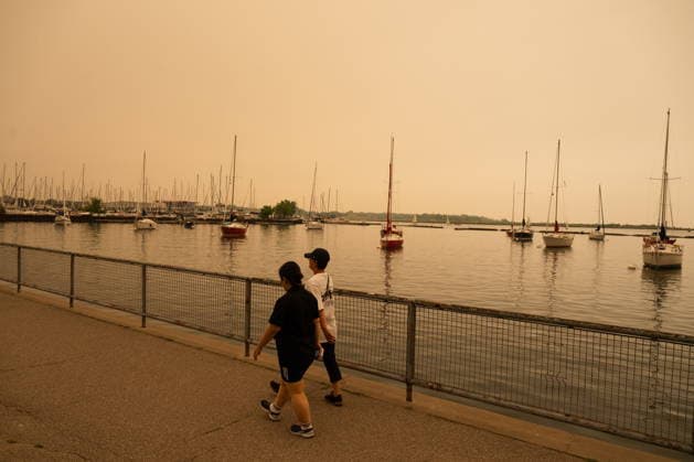 July 15, 2026, Toronto, On, Canada: People walk on the waterfront in Toronto as wildfire smoke fills the city, on Wednesday, July 15, 2026. Toronto Canada  - ZUMAc35_ 20260715_zaf_c35_007 Copyright: xLauraxProctorx