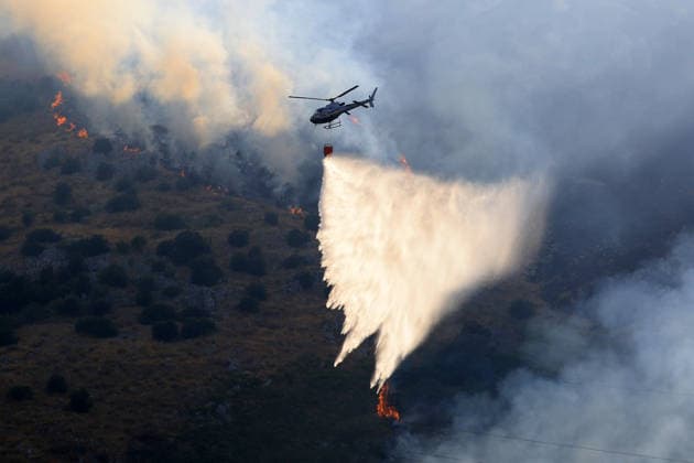 Italy battles extreme heat and wildfires PALERMO, ITALY - JULY 15: Firefighters battle the fire with firefighting aircraft and helicopters in an effort to bring it under control as a wildfire that broke out in the maquis vegetation on the slopes of Mount Longa spreading rapidly due to strong winds near Palermo, Sicily, Italy, on July 15, 2026. Alberto Lo Bianco Anadolu Palermo Italy. Editorial use only. Please get in touch for any other usage.  Copyright: x2026xAnadoluxAlbertoxLoxBiancox