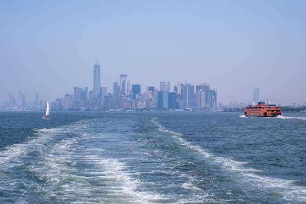 July 15, 2026, New York, New York, USA: Hazy skyline of Manhattan from the Staten Island Ferry as smoke from the Canadian wildfires moves over the city...Both heat and Air Quality Health Advisories are in effect New York City as smoke from Canadian wildfires coincide with temperatures expected to reach near100Ã‚Â°F as a heatwave continues. New York USA  - ZUMAp288 20260715_znp_p288_024 Copyright: xSyndixPilarx