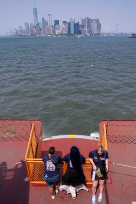 July 15, 2026, New York, New York, USA: Tourists take in the hazy view of the Manhattan Skyline from the Staten Island Ferry as smoke from the Canadian wildfires moves over the city...Both heat and Air Quality Health Advisories are in effect New York City as smoke from Canadian wildfires coincide with temperatures expected to reach near100Ã‚Â°F as a heatwave continues. New York USA  - ZUMAp288 20260715_znp_p288_029 Copyright: xSyndixPilarx