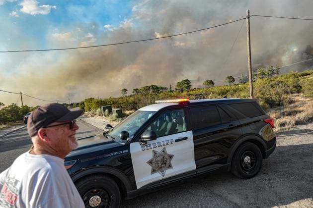 July 15, 2026, Boulevard, California, United States: A resident in the area watches the wildfire on the road..The Thorn Fire burns near Buckthorn Trail and Clover Trail in the Boulevard Campo area of southeastern San Diego County on Wednesday, July 15, 2026. Fueled by hot, dry conditions, the wildfire spreads rapidly, prompts evacuation orders and warnings, temporarily closes portions of Interstate 8, and draws a large response from Cal Fire and local agencies. Firefighters on the ground, supported by air tankers and helicopters, work to slow the fire s advance and protect nearby homes and infrastructure as officials monitor changing fire conditions. Boulevard United States  - ZUMAs197 20260715_aaa_s197_298 Copyright: xWaixLeexMichaelxHox