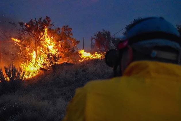 July 15, 2026, Boulevard, California, United States: A photojournalist takes photos of the fire along the road..The Thorn Fire burns near Buckthorn Trail and Clover Trail in the Boulevard Campo area of southeastern San Diego County on Wednesday, July 15, 2026. Fueled by hot, dry conditions, the wildfire spreads rapidly, prompts evacuation orders and warnings, temporarily closes portions of Interstate 8, and draws a large response from Cal Fire and local agencies. Firefighters on the ground, supported by air tankers and helicopters, work to slow the fire s advance and protect nearby homes and infrastructure as officials monitor changing fire conditions. Boulevard United States  - ZUMAs197 20260715_aaa_s197_318 Copyright: xWaixLeexMichaelxHox