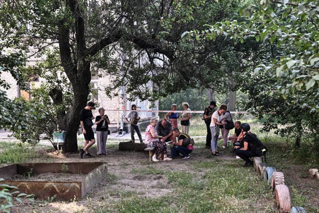 Locals evacuated from a three-storey apartment block damaged by a Russian airstrike due to the threat of collapse remain outdoors in Zaporizhzhia, Ukraine, July 15, 2026. The Russian army attacked the southeastern city with guided aerial bombs, killing three people and injuring at least 15 others. The strikes also damaged critical and civilian infrastructure. (Photo by Dmytro Smolienko Ukrinform) Russia launches another air strike on Zaporizhzhia  Copyright: xDmytroxSmolienkox