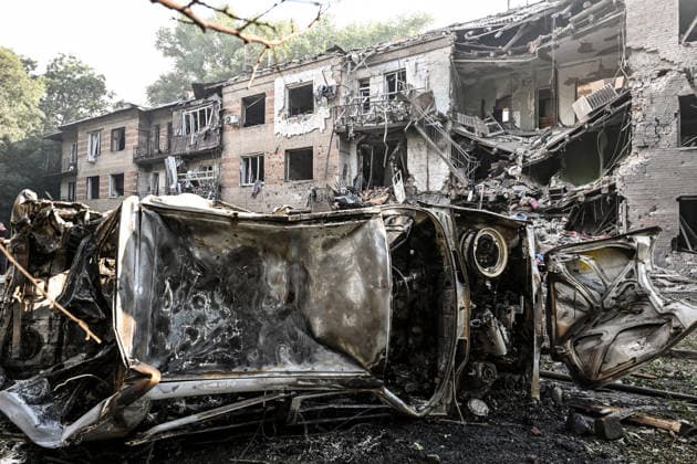 A burnt-out car lies on its side outside a three-storey apartment block damaged by a Russian airstrike, Zaporizhzhia, Ukraine, July 15, 2026. The Russian army attacked the southeastern city with guided aerial bombs, killing three people and injuring at least 15 others. The strikes also damaged critical and civilian infrastructure. (Photo by Dmytro Smolienko Ukrinform) Russia launches another air strike on Zaporizhzhia  Copyright: xDmytroxSmolienkox