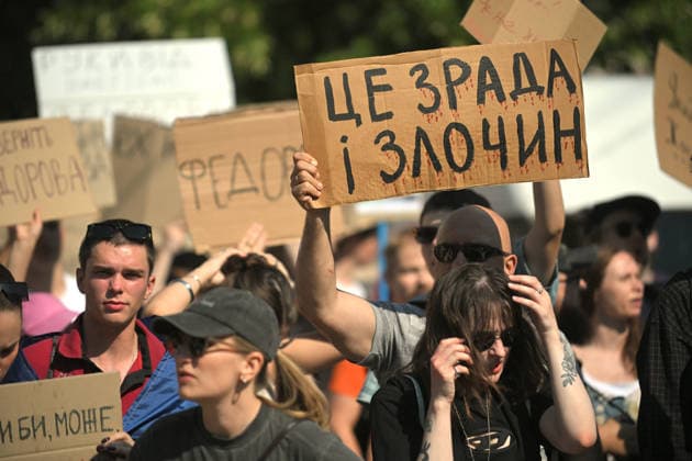 A demonstrator holds a placard reading It’s Treason and Crime during a rally against the dismissal of Ukrainian Defence Minister Mykhailo Fedorov, Kyiv, Ukraine, July 16, 2026. On July 14, the Ukrainian Parliament supported the resignation of Prime Minister Yuliia Svyrydenko, leading to the resignation of the Cabinet of Ministers. (Photo by Yevhen Kotenko Ukrinform) Protest action against dismissal of Ukrainian Defence Minister Mykhailo Fedorov in Kyiv  Copyright: xYevhenxKotenkox