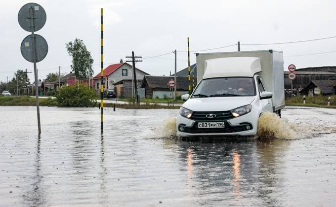 Russia Floods 9206464 16.07.2026 A car drives through a flooded road after heavy rains caused rivers to rise in the Irbitsky District of Sverdlovsk Region, Russia. Irina Semenova Sputnik Sverdlovsk Oblast Region Russia  Copyright: xIrinaxSemenovax