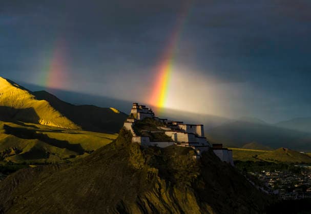 SHIGATSE CHINA - JULY 16: Double rainbow hangs in the sky above Jiangzi Zongshan Castle on July 16, 2026 in Jiangzi, Xizang Autonomous Region of China.  Copyright: xVCGx 111654720371