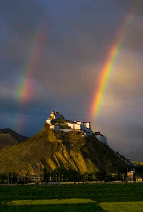 SHIGATSE CHINA - JULY 16: Double rainbow hangs in the sky above Jiangzi Zongshan Castle on July 16, 2026 in Jiangzi, Xizang Autonomous Region of China.  Copyright: xVCGx 111654720365