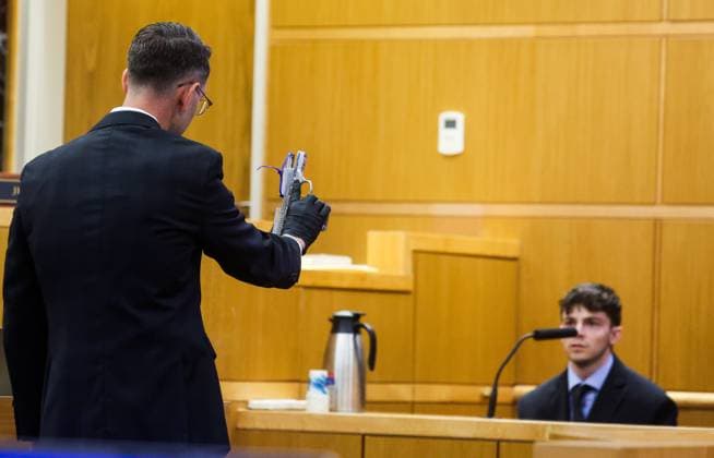 July 16, 2026, Clearwater, Florida, USA: Assistant State Attorney Nash Licona, left, holds the murder weapon as he cross examines the defendant, Stuart Beck, while Beck takes the stand and testifies in his murder trial at the Pinellas County Justice Center on Thursday, July 16, 2026 in Clearwater. Beck is on trial for shooting and killed Michael Conrad. Clearwater USA - ZUMAs70_ 20260716_zan_s70_020 Copyright: xDirkxShaddx