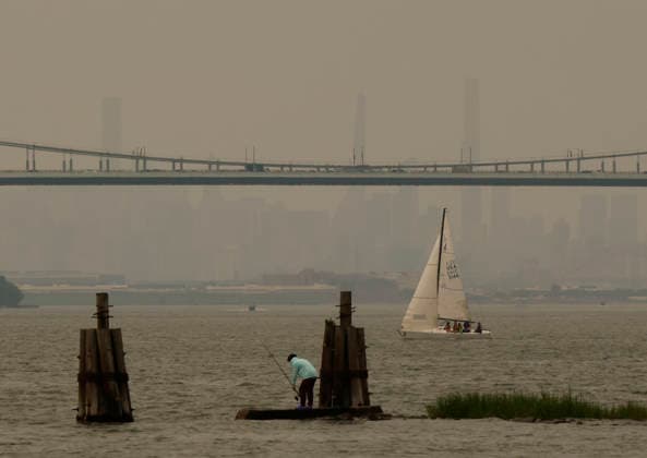 Smoke from wildfires in Canada drop hazy skies on the Manhattan skyline in the late morning on Thursday, July 16, 2026 in New York City. All of New York State, including New York City, and parts of New Jersey are under an Air Quality Advisory due to the smoke from more than 100 wildfires burning in Canada.  NYP202607161005 JOHNxANGELILLO