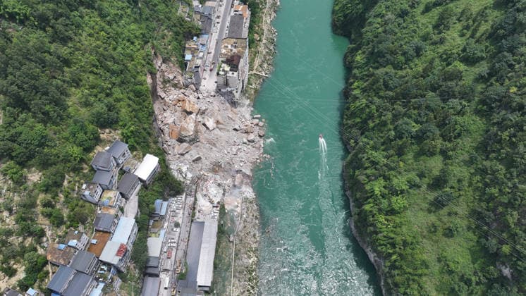 (260717) -- CHONGQING, July 17, 2026 -- An aerial drone photo taken on July 17, 2026 shows the site of a rainfall-induced landslide along a section of the Wujiang River in southwest China s Chongqing Municipality. Nine people have so far been rescued after a rainfall-induced landslide occurred along a section of the Wujiang River in southwest China s Chongqing Municipality on Friday. None of those rescued sustained life-threatening injuries, according to local authorities of Pengshui Miao and Tujia Autonomous County in Chongqing. The geological disaster saw massive amounts of rock and soil wash downslope at 9:08 a.m. Friday, burying more than 10 residential buildings, leaving local residents trapped and unaccounted for. ) (SpotNews) 