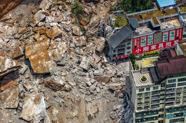 (260717) -- CHONGQING, July 17, 2026 -- An aerial drone photo taken on July 17, 2026 shows the site of a rainfall-induced landslide along a section of the Wujiang River in southwest China s Chongqing Municipality. Nine people have so far been rescued after a rainfall-induced landslide occurred along a section of the Wujiang River in southwest China s Chongqing Municipality on Friday. None of those rescued sustained life-threatening injuries, according to local authorities of Pengshui Miao and Tujia Autonomous County in Chongqing. The geological disaster saw massive amounts of rock and soil wash downslope at 9:08 a.m. Friday, burying more than 10 residential buildings, leaving local residents trapped and unaccounted for. ) (SpotNews) 
