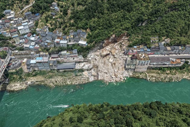 (260717) -- CHONGQING, July 17, 2026 -- An aerial drone photo taken on July 17, 2026 shows the site of a rainfall-induced landslide along a section of the Wujiang River in southwest China s Chongqing Municipality. Nine people have so far been rescued after a rainfall-induced landslide occurred along a section of the Wujiang River in southwest China s Chongqing Municipality on Friday. None of those rescued sustained life-threatening injuries, according to local authorities of Pengshui Miao and Tujia Autonomous County in Chongqing. The geological disaster saw massive amounts of rock and soil wash downslope at 9:08 a.m. Friday, burying more than 10 residential buildings, leaving local residents trapped and unaccounted for. ) (SpotNews) 