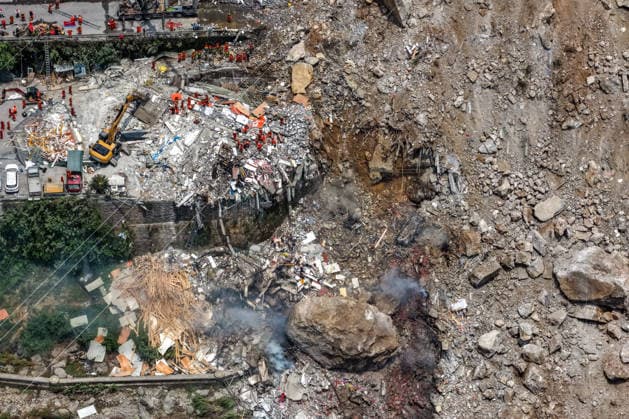 (260717) -- CHONGQING, July 17, 2026 -- An aerial drone photo taken on July 17, 2026 shows the site of a rainfall-induced landslide along a section of the Wujiang River in southwest China s Chongqing Municipality. Nine people have so far been rescued after a rainfall-induced landslide occurred along a section of the Wujiang River in southwest China s Chongqing Municipality on Friday. None of those rescued sustained life-threatening injuries, according to local authorities of Pengshui Miao and Tujia Autonomous County in Chongqing. The geological disaster saw massive amounts of rock and soil wash downslope at 9:08 a.m. Friday, burying more than 10 residential buildings, leaving local residents trapped and unaccounted for. ) (SpotNews) 