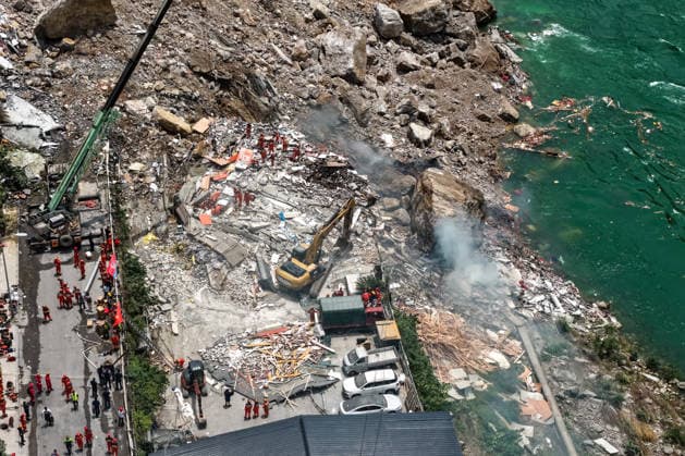 (260717) -- CHONGQING, July 17, 2026 -- An aerial drone photo taken on July 17, 2026 shows the site of a rainfall-induced landslide along a section of the Wujiang River in southwest China s Chongqing Municipality. Nine people have so far been rescued after a rainfall-induced landslide occurred along a section of the Wujiang River in southwest China s Chongqing Municipality on Friday. None of those rescued sustained life-threatening injuries, according to local authorities of Pengshui Miao and Tujia Autonomous County in Chongqing. The geological disaster saw massive amounts of rock and soil wash downslope at 9:08 a.m. Friday, burying more than 10 residential buildings, leaving local residents trapped and unaccounted for. ) (SpotNews) 