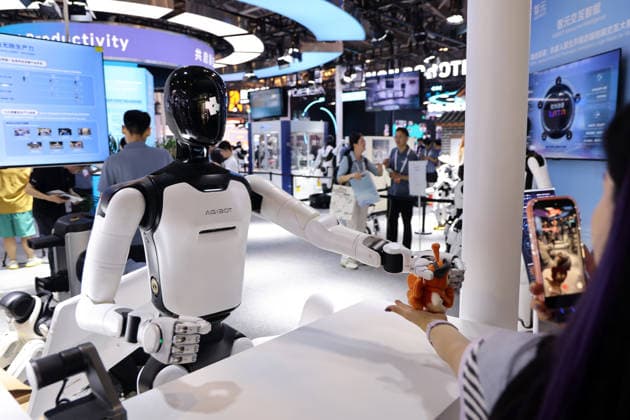 SHANGHAI, CHINA - JULY 17: A humanoid robot interacts with a visitor during the 2026 World AI Conference and High-Level Meeting on Global AI Governance on July 17, 2026 in Shanghai, China. Themed AI Partnership for a Brighter Future, the event will include more than 140 forums, bringing together 1,400 guests from home and abroad.  Copyright: xChinaxNewsxServicex 111654825171