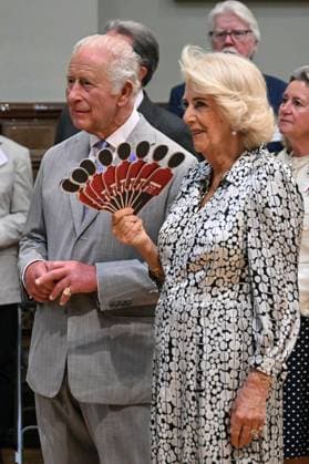 Charles and Camilla visit Blandford Forum Britain s Queen Camilla (R) fans Britain s King Charles III (L) as they listen to a performance of Dorset Opera, during a visit to the Main Hall at the Blandford Forum Town Hall and Corn Exchange in Blandford Forum, Dorset, south-west England on July 16, 2026., Credit:JUSTIN TALLIS PA ROTA - B68 Avalon United Kingdom, Dorset, Blandford Forum  Copyright: xJUSTINxTALLISx xPAxROTAx-xB68x xAvalonx 1117025660