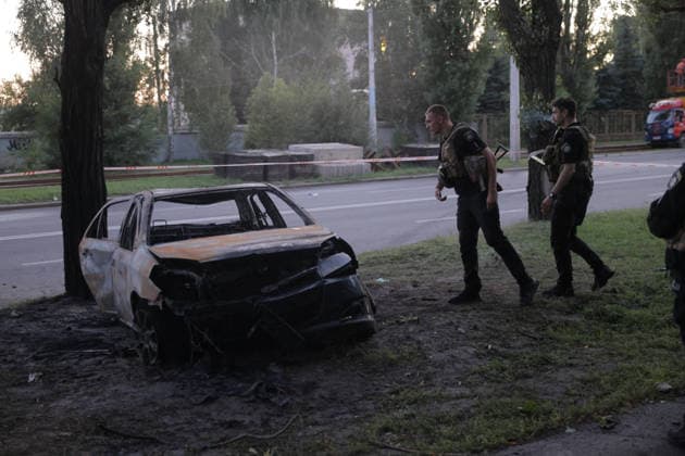 July 17, 2026, Kharkiv, Kharkiv Oblast, ukraine: A burned-out vehicle lies near a tree following a russian Banderol missile strike in Shevchenkivskyi District, kharkiv, ukraine on July 17, 2026. Emergency personnel in tactical gear investigate the scene; the strike killed one 40-year-old man in his vehicle and wounded seven others who were hospitalized. Kharkiv ukraine  - ZUMAt164 20260717_zip_t164_004 Copyright: xYevhenxTitovx