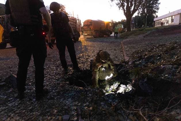 July 17, 2026, Kharkiv, Kharkiv Oblast, Ukraine: A person sits in debris following a russian banderol missile strike on a road in Kharkiv s Shevchenkivskyi District on July 17, 2026. The attack killed a 40-year-old man in his vehicle and injured nine others, damaging educational, administrative and commercial buildings in the area. Kharkiv Ukraine  - ZUMAt164 20260717_zip_t164_018 Copyright: xYevhenxTitovx