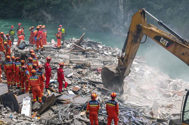 (260718) -- CHONGQING, July 18, 2026 -- Rescuers work at the site of a mountain collapse in Pengshui Miao and Tujia Autonomous County, southwest China s Chongqing Municipality, July 17, 2026. Eight people have been confirmed dead and 34 others remain missing after a rainfall-induced mountain collapse occurred along a section of the Wujiang River in southwest China s Chongqing Municipality on Friday, local authorities said. Ten people have been rescued, and search and rescue operations are underway, according to a press briefing held on Friday night. The geological disaster occurred at 9:08 a.m. on Friday in the Hanjia sub-district of Pengshui Miao and Tujia Autonomous County in Chongqing, burying more than 10 residential buildings, w 