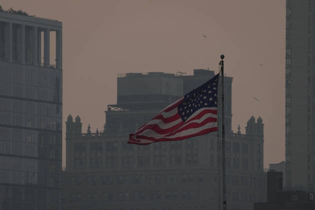 July 18, 2026, New York, New York, USA: An American flag flies as the smoke from Canadian Wildfires hangs over Manhattan on July 18, 2026 in New York. More than 200 wildfires are burning in Canada causing smoke to drift across the United States spiking the air quality index. New York USA - ZUMAb148 20260718_zap_b148_011 Copyright: xBryanxSmithx