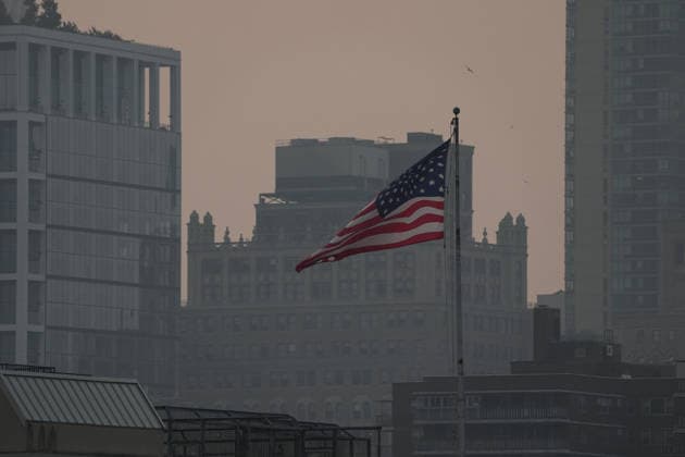 July 18, 2026, New York, New York, USA: An American flag flies as the smoke from Canadian Wildfires hangs over Manhattan on July 18, 2026 in New York. More than 200 wildfires are burning in Canada causing smoke to drift across the United States spiking the air quality index. New York USA - ZUMAb148 20260718_zap_b148_027 Copyright: xBryanxSmithx