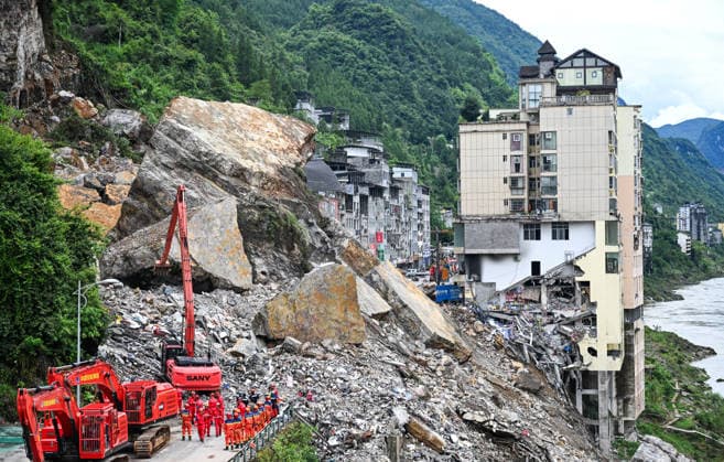 (260718) -- CHONGQING, July 18, 2026 -- Rescuers work at the site of a mountain collapse in Pengshui Miao and Tujia Autonomous County, southwest China s Chongqing Municipality, July 18, 2026. The geological disaster occurred at 9:08 a.m. on Friday in the Hanjia sub-district of Pengshui Miao and Tujia Autonomous County in Chongqing, burying more than 10 residential buildings, while leaving some local residents trapped and unaccounted for. More than 800 rescuers and over 1,100 sets of equipment have been deployed for on-site search and rescue operations. ) CHINA-CHONGQING-MOUNTAIN COLLAPSE-RESCUE (CN) WangxQuanchao 