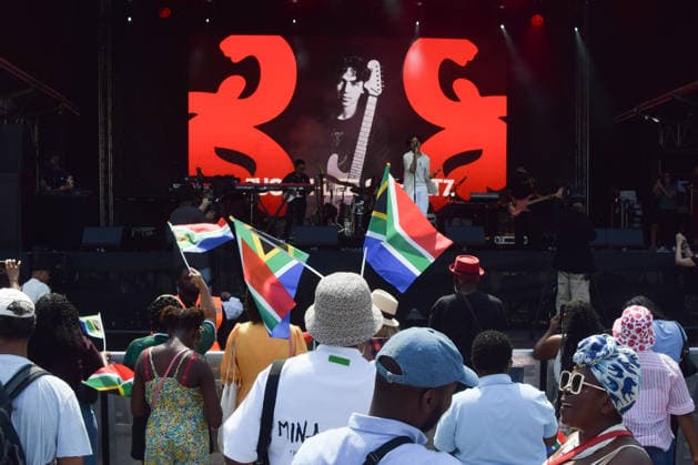 July 18, 2026, London, England, United Kingdom: Audience members wave South African flags during a set by singer JUSTIN LEE SCHULTZ at the Nelson Mandela Day celebration in Trafalgar Square, honouring the life and legacy of Nelson Mandela. This year also marks the 30th anniversary of the South African Constitution. London United Kingdom - ZUMAv130 20260718_zip_v130_051 Copyright: xVukxValcicx