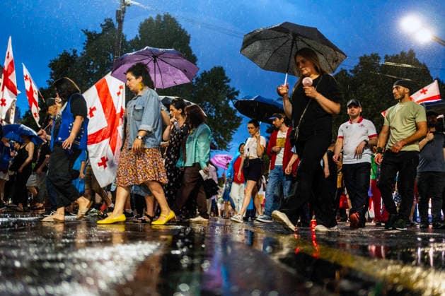 July 18, 2026, Tbilisi, Georgia: People chant slogans under heavy rain as they mark 598th day of anti-government rally in Tbilisi, Georgia. Tbilisi Georgia - ZUMAz174 20260718_zip_z174_002 Copyright: xMoexZoyarix