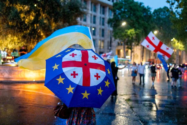 July 18, 2026, Tbilisi, Georgia: Protesters wave flags of Georgia and Ukraine under heavy rain as they mark 598th day of anti-government rally in Tbilisi, Georgia. Tbilisi Georgia - ZUMAz174 20260718_zip_z174_006 Copyright: xMoexZoyarix