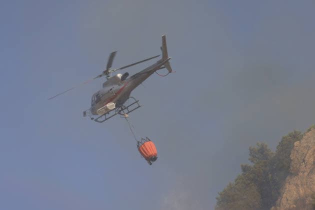 Forest fires continue on the Italian island of Sicily PALERMO, ITALY - JULY 18: A helicopter is carrying water to respond to a forest fire spreading across the slopes of Mount Iato near Palermo on the island of Sicily, Italy, on July 18, 2026, as ground and air crews continue their efforts to contain the blaze. Forest fires breaking out at various points on the island are continuing. Alberto Lo Bianco Anadolu Palermo Italy. Editorial use only. Please get in touch for any other usage.  Copyright: x2026xAnadoluxAlbertoxLoxBiancox