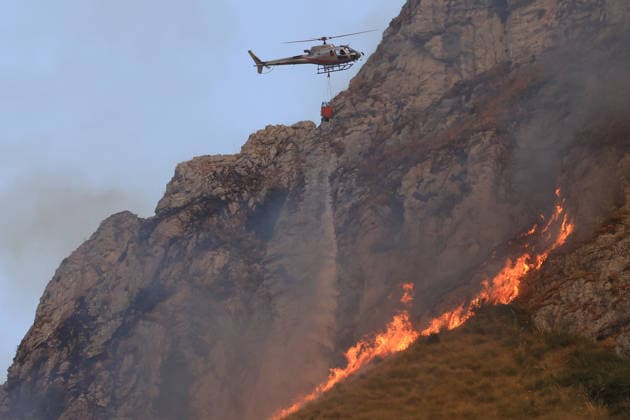 Forest fires continue on the Italian island of Sicily PALERMO, ITALY - JULY 18: A helicopter is dropping water to tackle a forest fire spreading across the slopes of Mount Iato near Palermo on the island of Sicily, Italy, on July 18, 2026, as ground and air crews continue their efforts to contain the blaze. Forest fires breaking out at various points on the island are continuing. Alberto Lo Bianco Anadolu Palermo Italy. Editorial use only. Please get in touch for any other usage.  Copyright: x2026xAnadoluxAlbertoxLoxBiancox