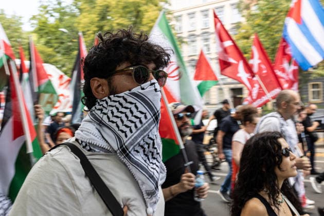 Pro-Palestinian demonstration in Berlin, Germany- 18 Jul 2026 A pro-Palestinian activist wearing a keffiyeh wrapped around his head and face and dark sunglasses takes part in a demonstration near the former Tempelhof Airport. Hundreds of people marched through the city center with drums, some wearing keffiyehs, traditional Palestinian scarves, while calling for an end to the wars in the Gaza Strip and Iran. Berlin Germany Copyright: xVasilyxKrestyaninovx xSOPAxImagesx _VKR5098