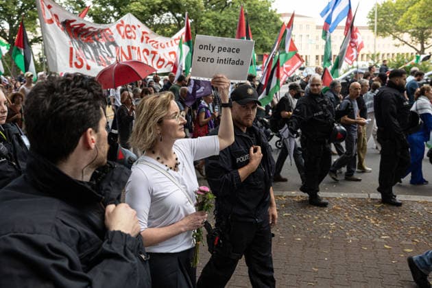 Pro-Palestinian demonstration in Berlin, Germany- 18 Jul 2026 German activist, lawyer and FDP politician Karoline Preisler walks with a placard reading Only Peace, Zero Intifada during a pro-Palestinian demonstration near Tempelhof Airport. Hundreds of people marched through the city center with drums, some wearing keffiyehs, traditional Palestinian scarves, while calling for an end to the wars in the Gaza Strip and Iran. Berlin Germany Copyright: xVasilyxKrestyaninovx xSOPAxImagesx _VKR5336