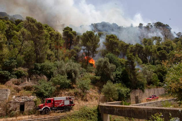 Wildfire Spreads Amid Heatwave in Sicily Fire burns among trees on a hill as firefighters arrive at the scene in Modica, Sicily, Italy, on July 18, 2026. Wildfires were reported in parts of Sicily as high temperatures persisted across the region. Modica Sicily Italy Copyright: xElvisxTakahashixMantellox