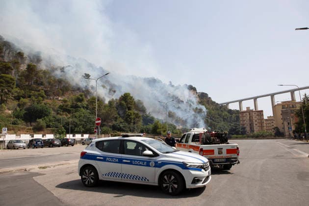 Wildfire Spreads Amid Heatwave in Sicily Authorities stand in front of a wildfire burning on a hillside in Modica, Sicily, Italy, on July 18, 2026. Firefighting crews responded to wildfires reported in parts of Sicily as high temperatures persisted across the region. Modica Sicily Italy Copyright: xElvisxTakahashixMantellox