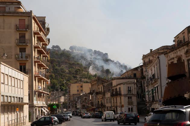 Wildfire Spreads Amid Heatwave in Sicily A firefighting helicopter drops water over a wildfire in Modica, Sicily, Italy, on July 18, 2026, during efforts to contain the blaze. Firefighting crews responded to wildfires reported in parts of Sicily as high temperatures persisted across the region. Modica Sicily Italy Copyright: xElvisxTakahashixMantellox