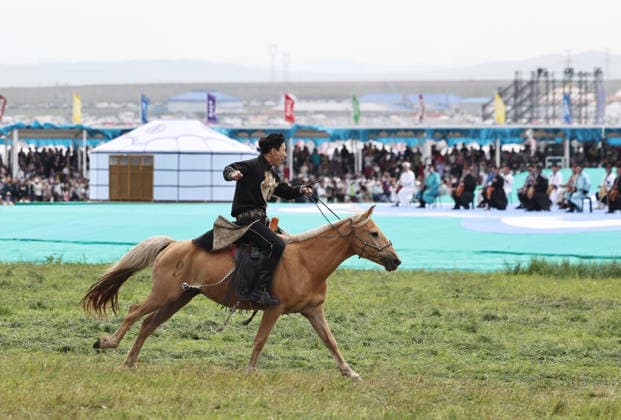 XILINGOL, CHINA - JULY 18: An artist performs with a horse at the opening ceremony of the 36th Naadam festival on July 18, 2026 in Xilingol League, Inner Mongolia Autonomous Region of China. The Naadam festival kicked off here on July 18. Naadam, usually held in mid-summer and sometimes in winter in pastoral areas of Inner Mongolia, means games in the Mongolian language. It often comprises wrestling, archery, and horse racing, also known as the Three Games of Men.  Copyright: xVCGx 111655158214