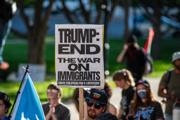 July 18, 2026, Salt Lake City, Utah, USA: A protester holds a sign reading Trump: End the War on Immigrants at Washington Square Park during an ICE OUT protest in Salt Lake City, Utah, on Saturday, July 18, 2026. The demonstration was organized to contest immigration policy following the recent fatal shootings of Lorenzo Salgado Araujo and Joan Sebastian Guerrero by federal immigration law enforcement agents. Salt Lake City USA  - ZUMAm292 20260718_znp_m292_005 Copyright: xCharlesxMcClintockxWilsonx